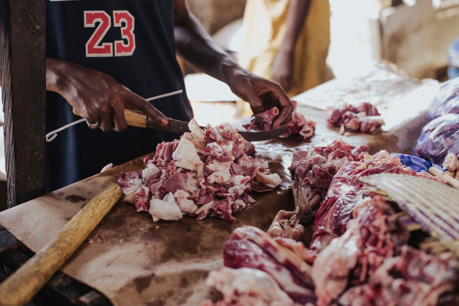 Professional butcher cutting and preparing quality meat