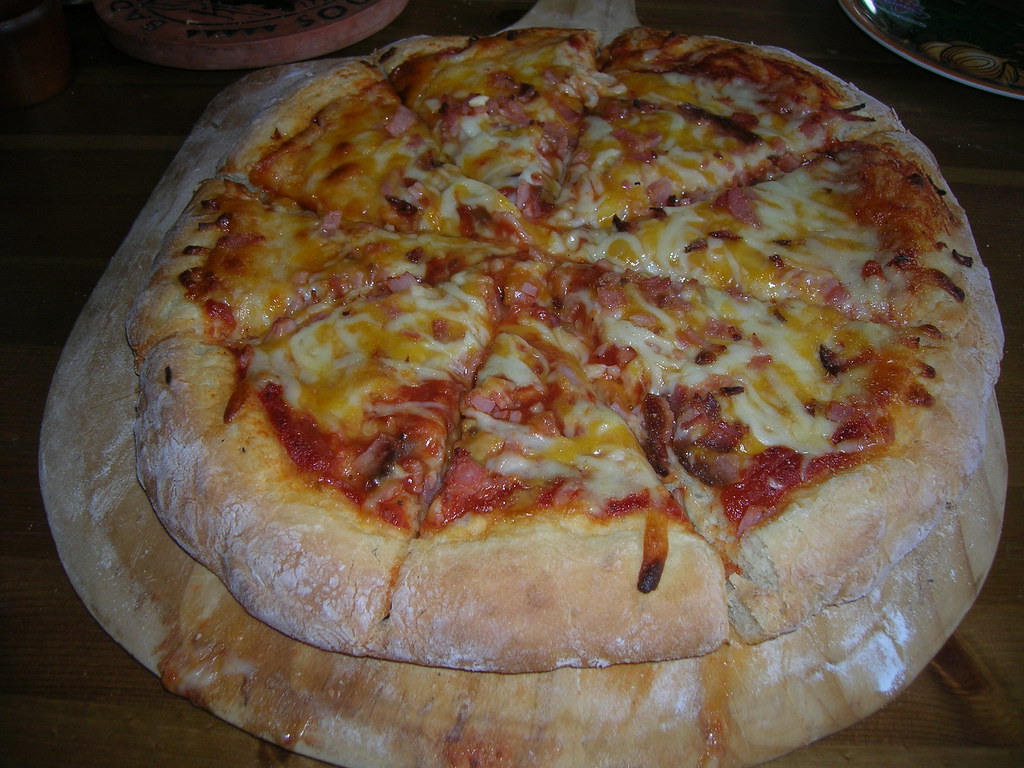 Handmade artisan pizza dough being prepared with fresh flour
