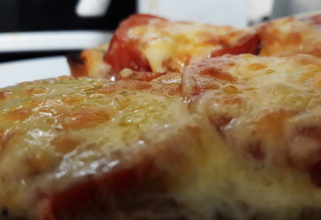 Delicious pizza slice with melting cheese and craft toppings
