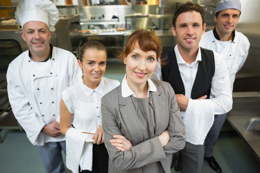 Professional restaurant team working together in kitchen